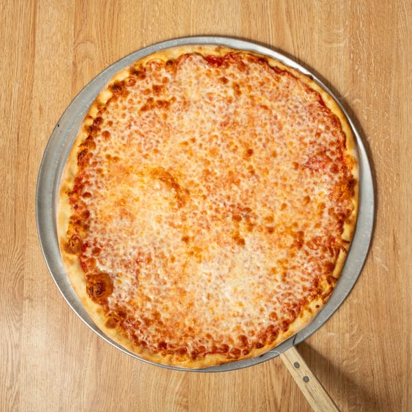 Classic cheese pizza with a golden crust on a metal pizza peel, resting on a wooden table.